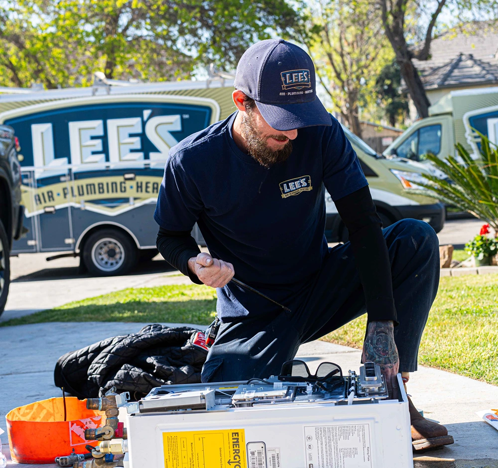 Lee's plumber installing a water heater