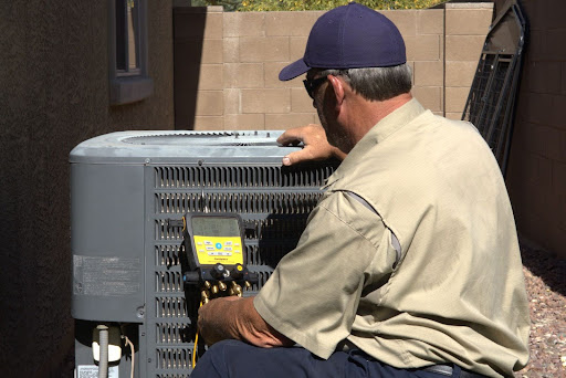Lee's technician performing AC maintenance.