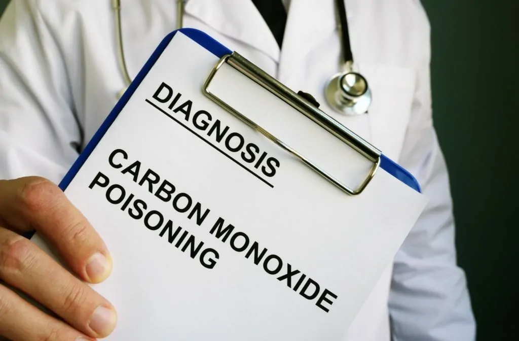 A doctor holding a clipboard with a piece of paper reading diagnosis carbon monoxide poisoning