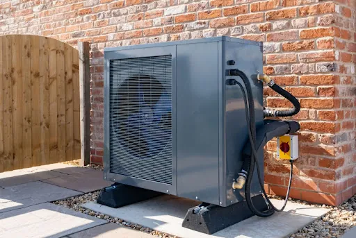 A heat pump unit installed outside of a house.